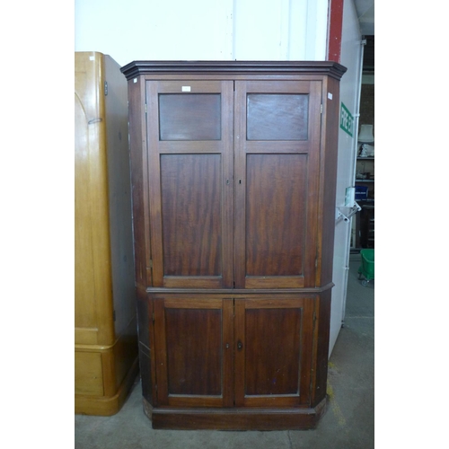 227b - A George III mahogany freestanding splay front corner cupboard