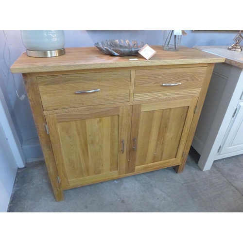 1473 - An oiled oak two door sideboard  *This lot is subject to VAT Marked to top right hand corner.