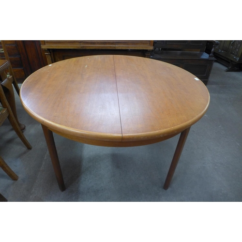 144 - A teak extending dining table