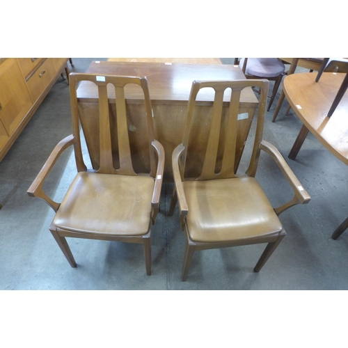 145 - A pair of teak elbow chairs