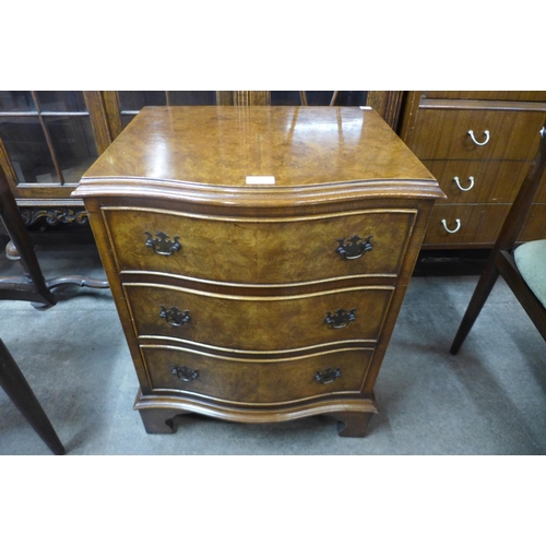 152a - A small burr walnut serpentine chest of drawers