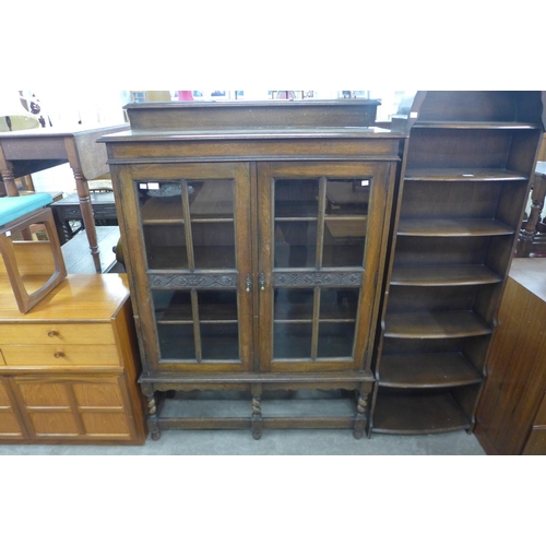 155 - A carved oak two door barleytwist bookcase