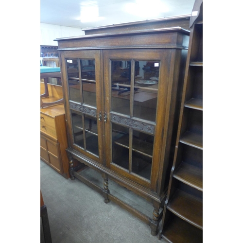 155 - A carved oak two door barleytwist bookcase