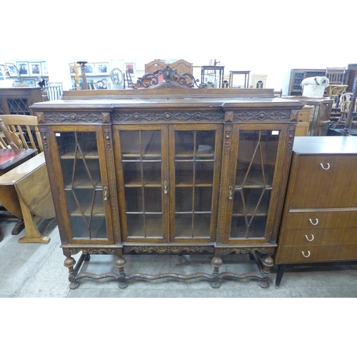 157 - An early 20th Century carved oak four door breakfront bookcase