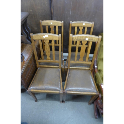 187 - A set of four oak dining chairs