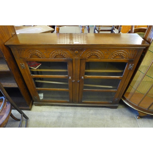 204 - A carved oak two door bookcase