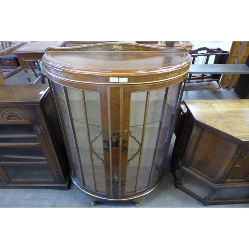 205 - A Japanned walnut bow fronted display cabinet