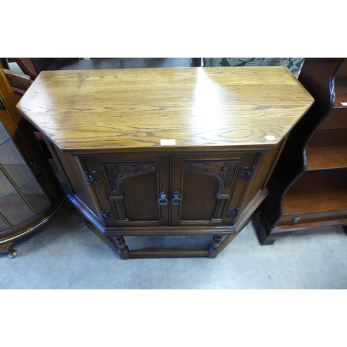 206 - A carved oak two door credence cupboard