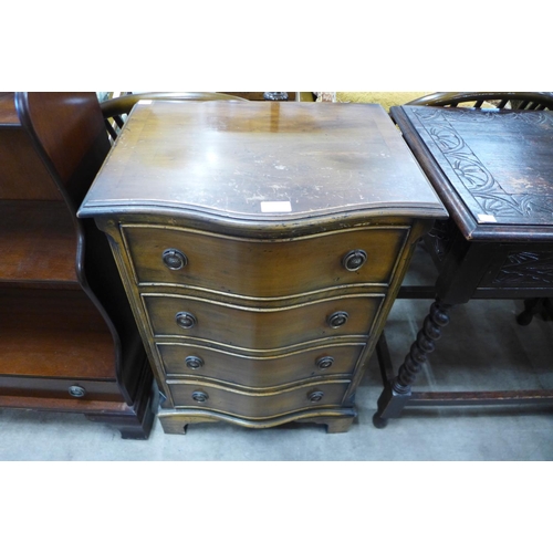 208 - A small yew wood serpentine chest of drawers