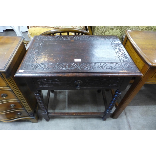 209 - A 16th Century style carved oak single drawer side table