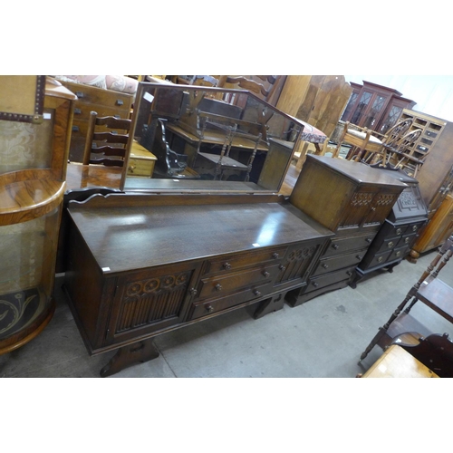 219 - A carved oak tallboy and matching dressing table