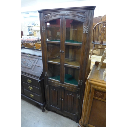 222 - An oak freestanding corner cabinet