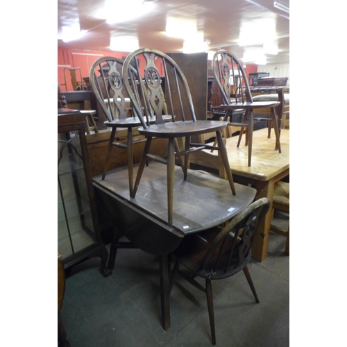 231 - An Ercol dark drop leaf table and four chairs