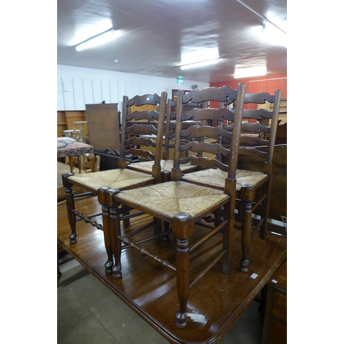 238 - A set of four oak and rush seated ladderback chairs