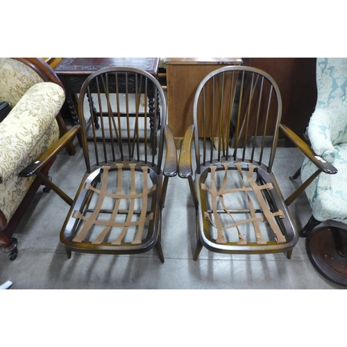 253 - A pair of Ercol dark low armchairs