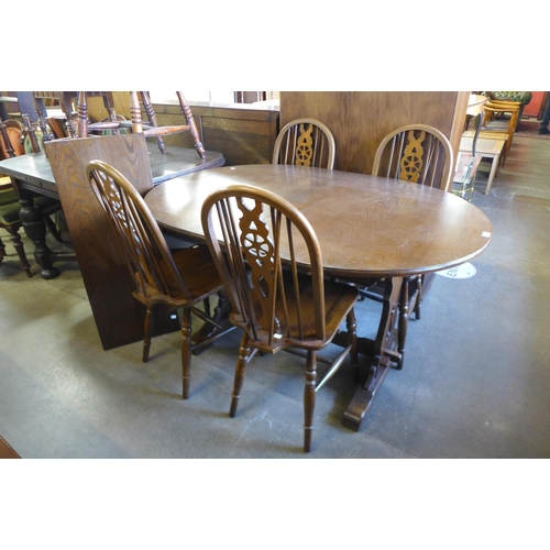 261 - An Old Charm oak extending dining table and four chairs