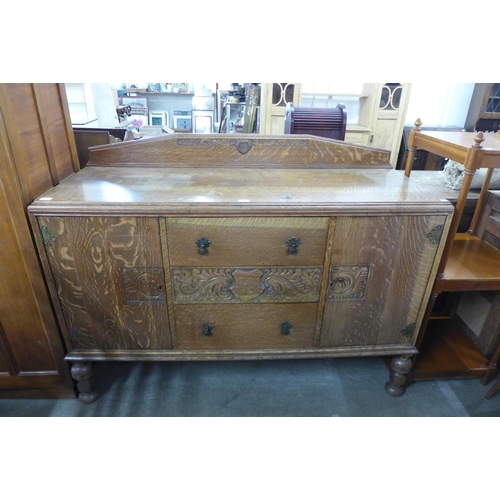 281 - A carved oak sideboard