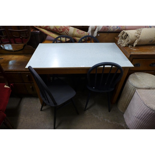 299 - A beech and Formica topped kitchen table and four Ercol painted chairs