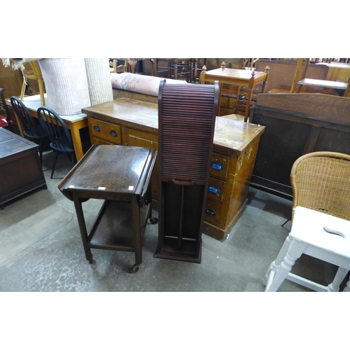 302 - An oak trolley and a hardwood tambour front CD cabinet