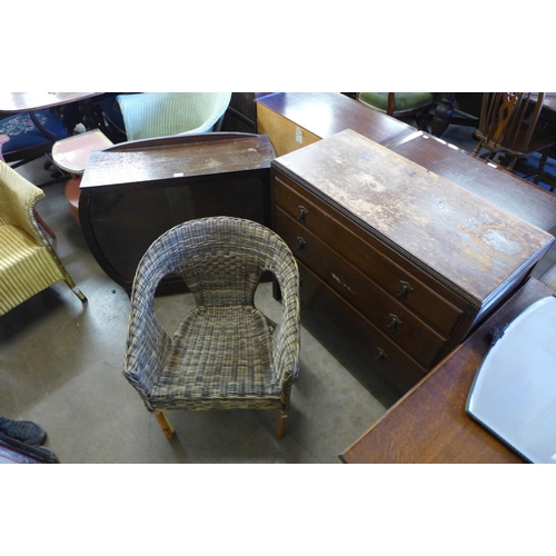 326 - An oak chest of drawers, a small display cabinet and a wicker chair