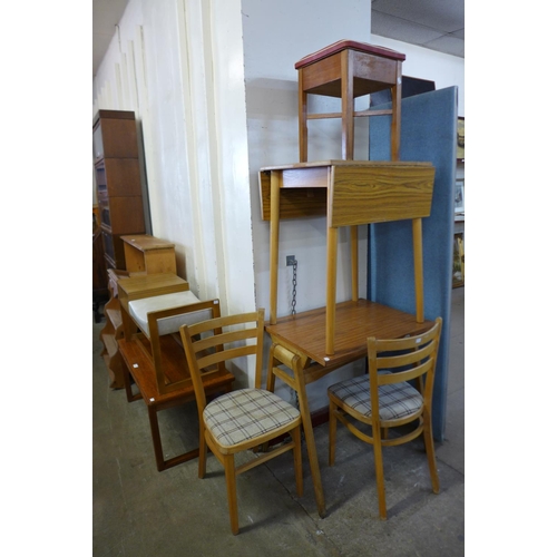 331 - A simulated rosewood drop-leaf kitchen table, two chairs, a teak coffee table, etc.