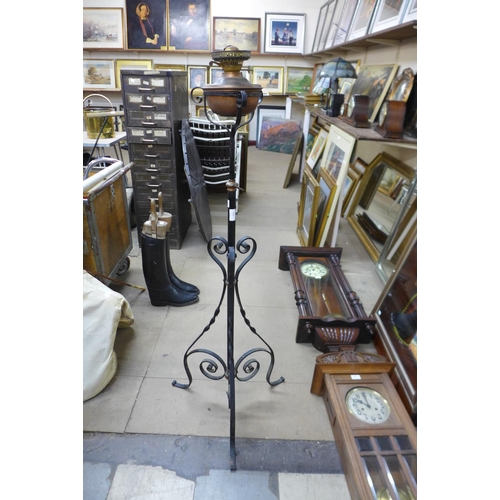 350 - An Art Nouveau wrought iron and copper floor standing oil lamp