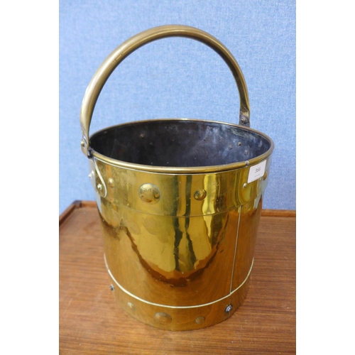 366 - An Arts and Crafts brass coal bucket