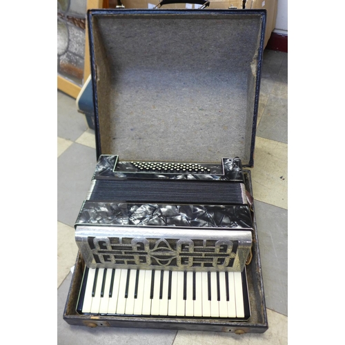 411 - A piano accordian, cased