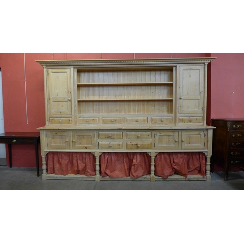 51 - A large George III style pine dresser, 204cma h, 290cms w, 56cms w