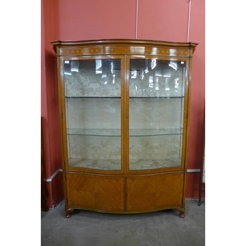 53 - A Victorian Sheraton Revival satinwood serpentine display cabinet, 168cms h, 145cns w, 42cms d