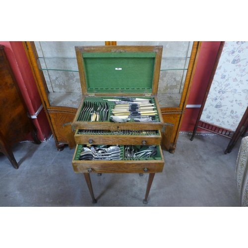 54 - An Edward VII oak canteen of cutlery cabinet on stand, including a quantity of plated flatware