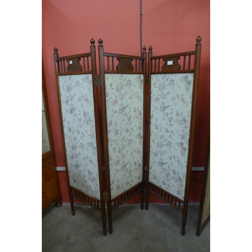 57 - An Arts and Crafts walnut and fabric panelled folding screen