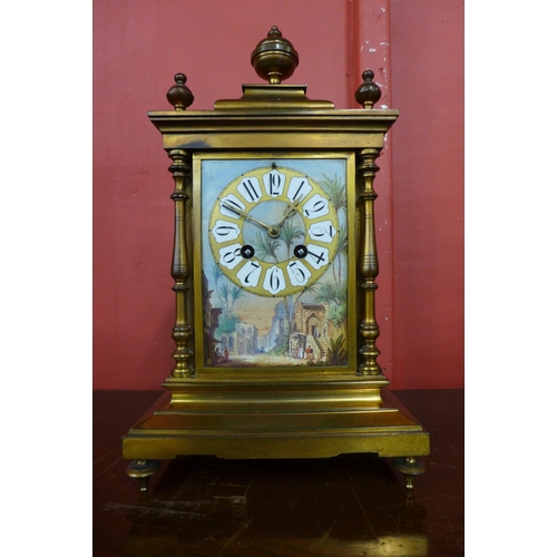 61 - A 19th Century French gilt metal mantel clock, with painted porcelain panels, 35cns h