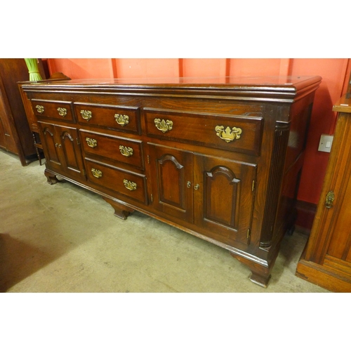 68 - A George III style oak and mahogany crossbanded dresser, 88cms h, 200cms w, 55cms d