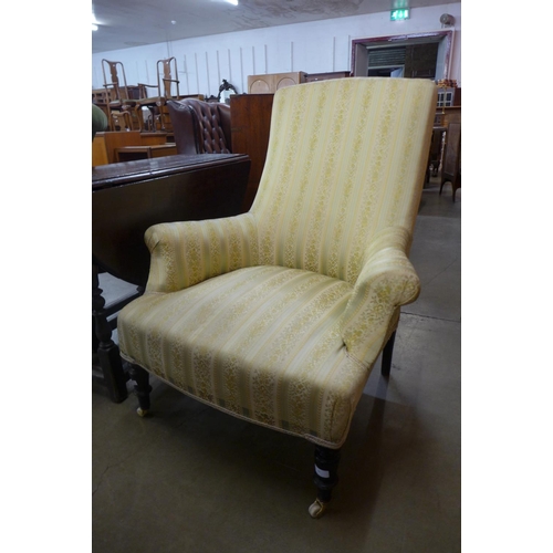 84 - A Victorian ebonised and upholstered armchair