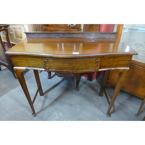 87 - An Edward VII mahogany serpentine single drawer side table, made by Henry Barker Ltd., Nottingham