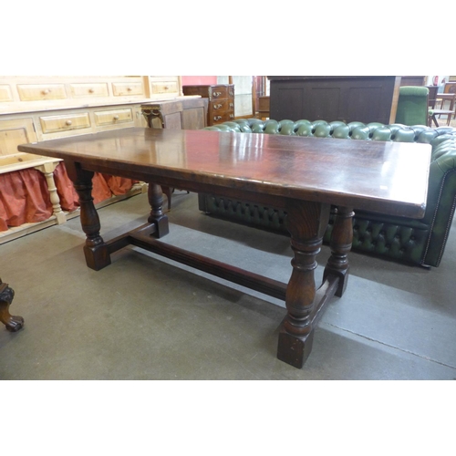 90 - An 18th Century style oak refectory table, 75cms h, 183cms l, 84cms w