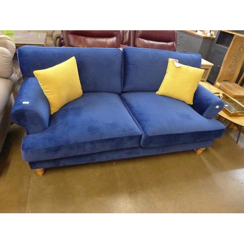 1302 - A blue velvet three seater sofa