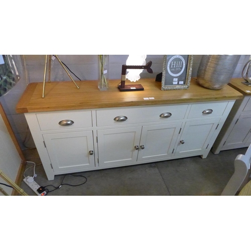 1457 - An oak and cream four door sideboard * this lot is subject to VAT Damaged marks to ends and top.