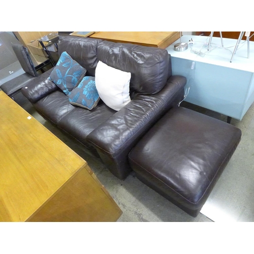 1872 - A brown leather two seater sofa and a footstool