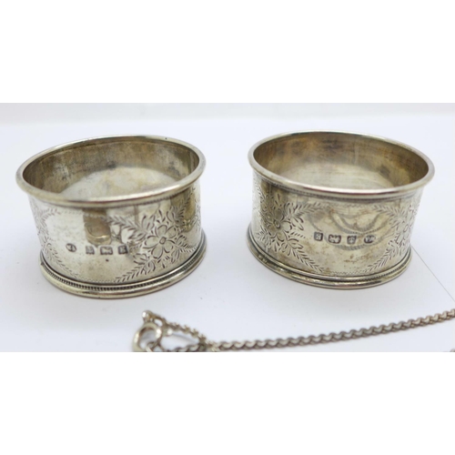 1124 - A pair of silver napkin rings and two silver lockets and a chain, 56g