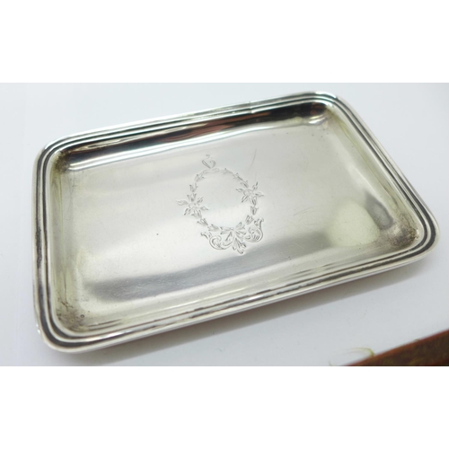 1127 - A small silver tray, Birmingham 1922, 49g, a silver nail buff, Birmingham 1911 and an embroidered si... 