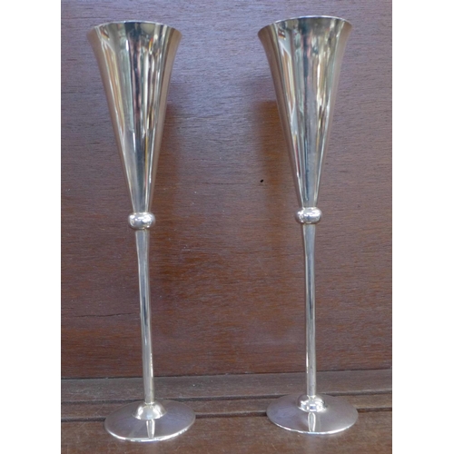 1134 - A pair of tall silver wine flutes with gilt interiors, by Carrs, cased, 470g