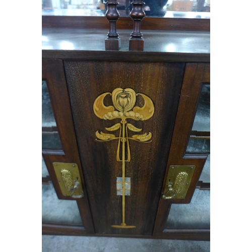 86 - An Arts and Crafts inlaid mahogany side cabinet