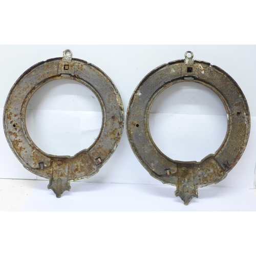 816 - A pair of circular cast plaques in the form of a belt