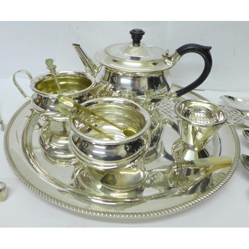 821 - A pair of silver sugar bows, 11.5g, a silver mounted fork, a three piece plated tea service and othe... 