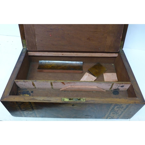 833 - A writing box, a cased set of drawing instruments, a slide rule and ruler