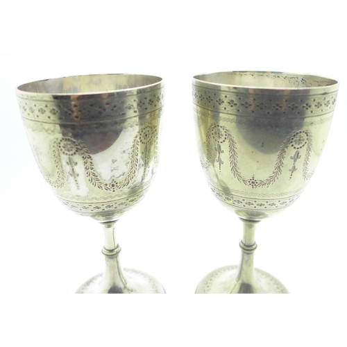 840 - A pair of silver plated engraved wine goblets