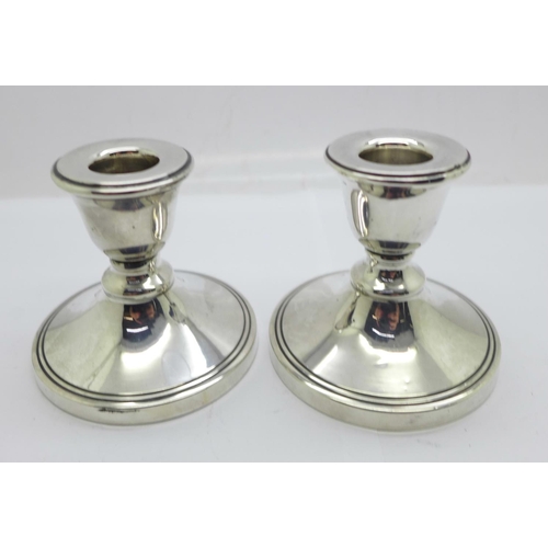 860 - Two silver dwarf candlesticks with Bakelite bases, Chester and Birmingham hallmarks