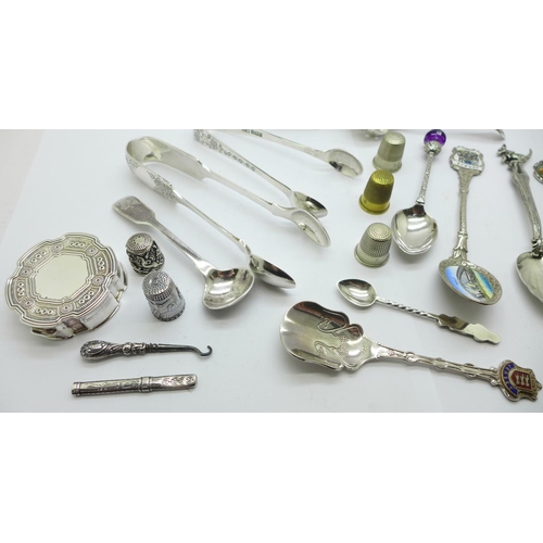 874 - A collection of silver, two pairs of sugar bows, pill box, mustard spoon, tooth pick, 137g and a col... 